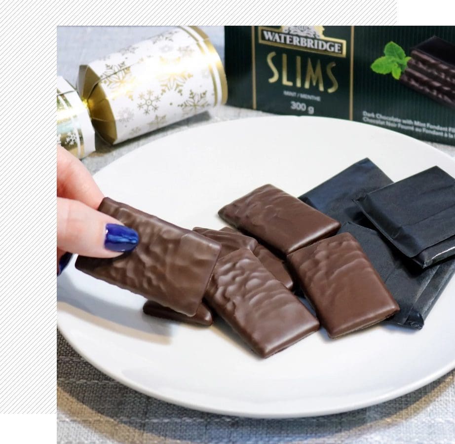 Plate of chocolate wafers beside packaging.