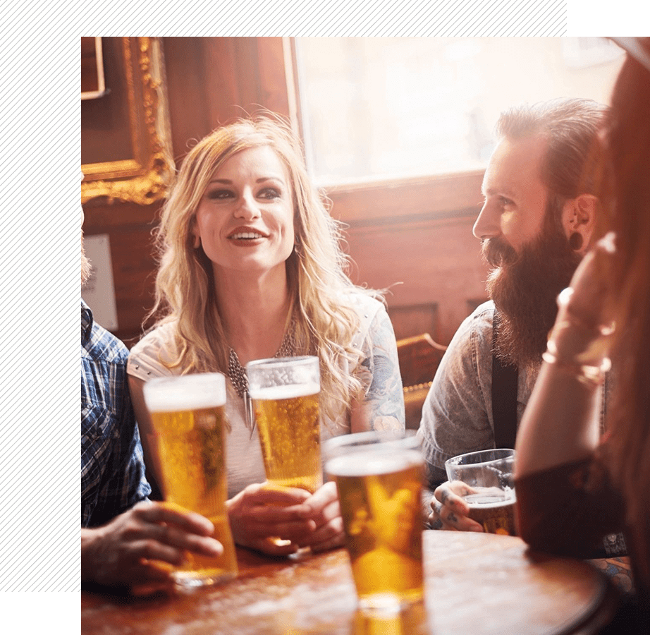 Group enjoying beer at a bar table.