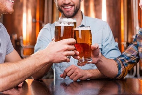 Group of friends toasting with beer glasses.