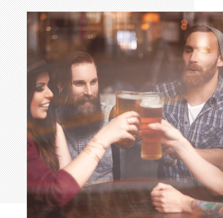 Friends clinking pints in a cozy pub