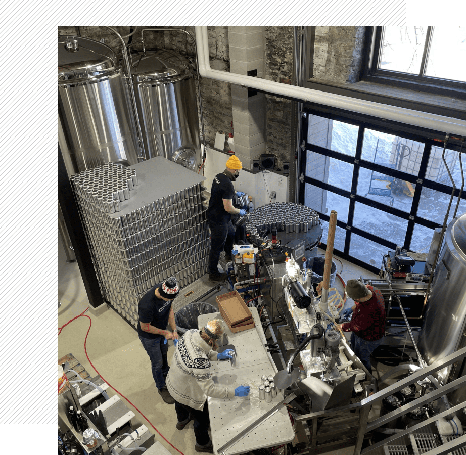 Brewery workers operating machinery and equipment.